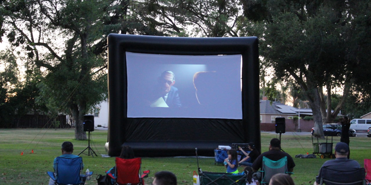 Families gather for summer movie in the park in Atwater